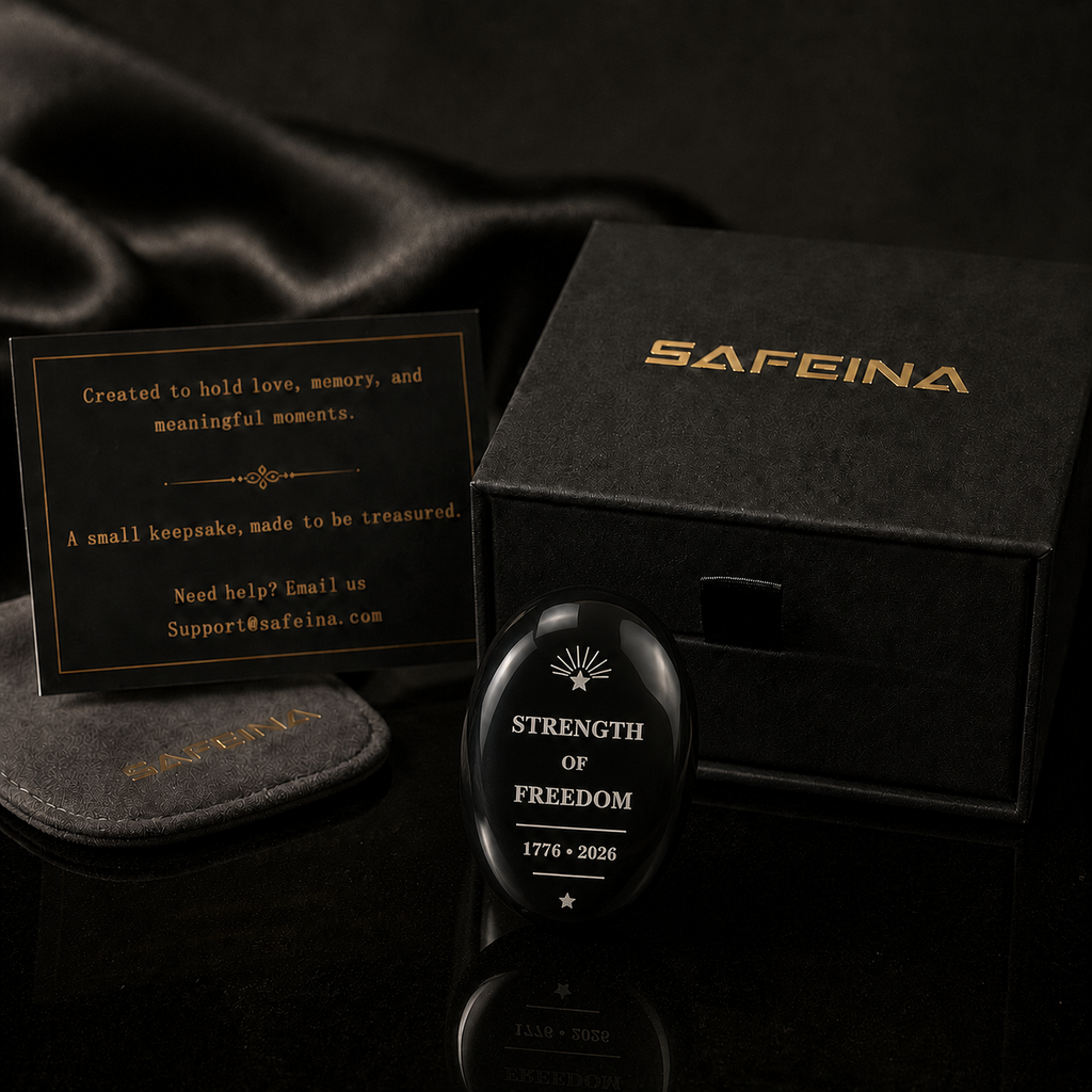 Black obsidian palm stone with laser engraved Strength of Freedom 1776–2026 design – front view, SAFEINA