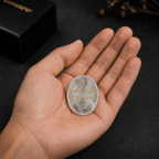 Close-up of laser engraved Liberty 250 design on white crystal keepsake palm stone – SAFEINA