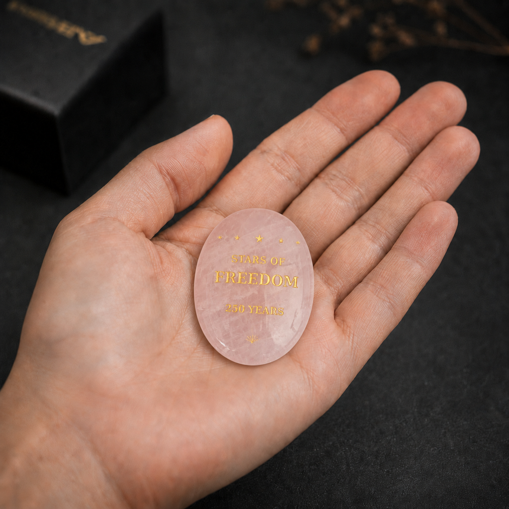 Close-up of laser engraved star pattern on rose quartz keepsake palm stone – SAFEINA