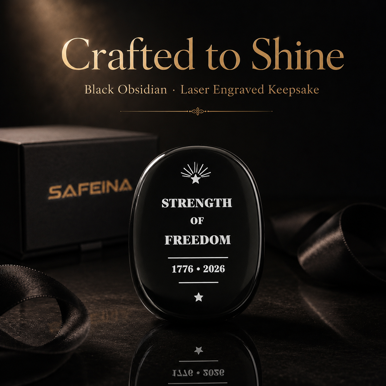 Black obsidian Strength of Freedom keepsake held in hand showing thin flat shape and approx. 40×30mm size